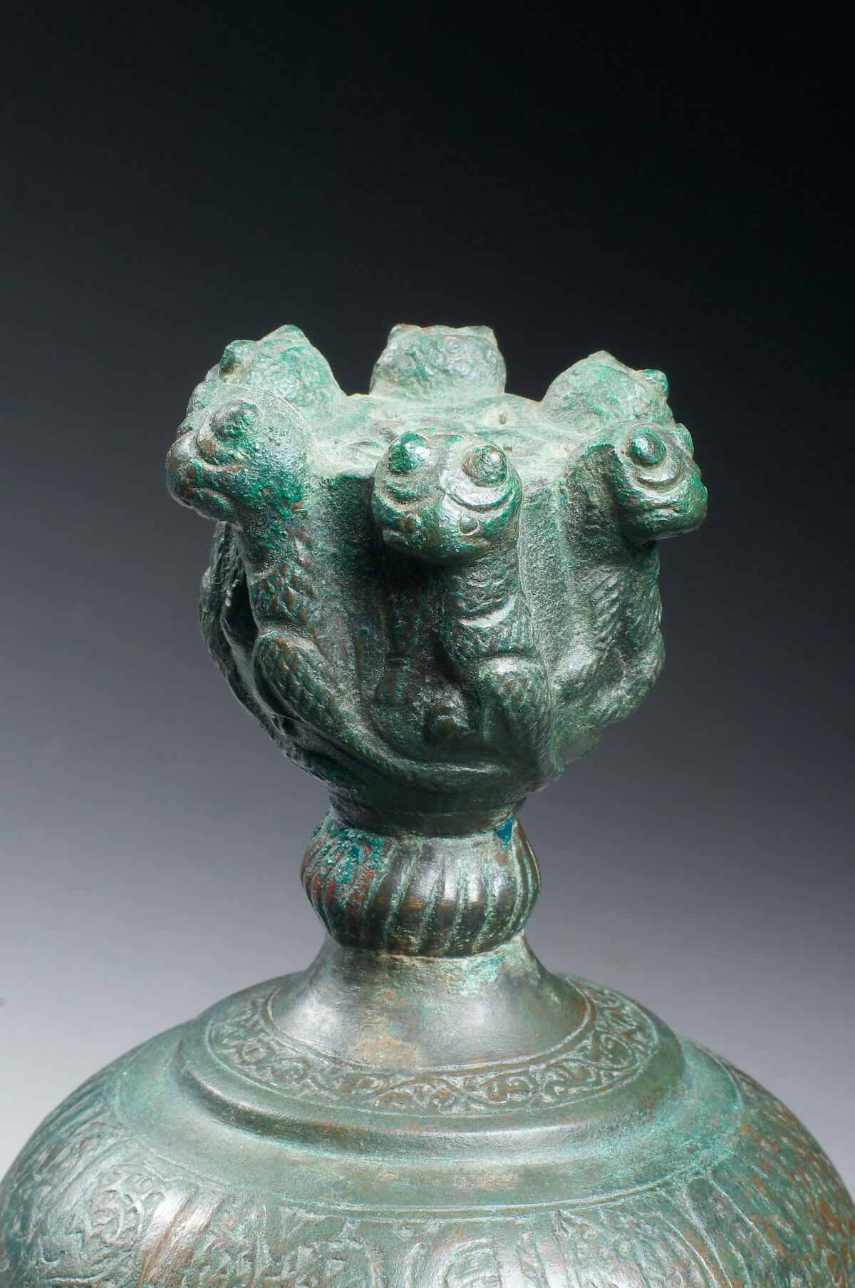 Bronze rosewater sprinkler with lions, inscriptions and panels enclosing animals (detail of the mouth with lions)
